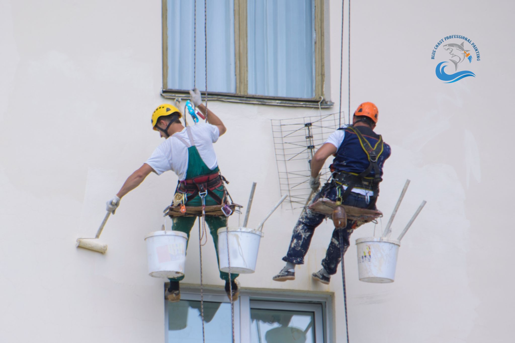 Painters doing exterior commercial painting of a building in Los Angeles, CA.