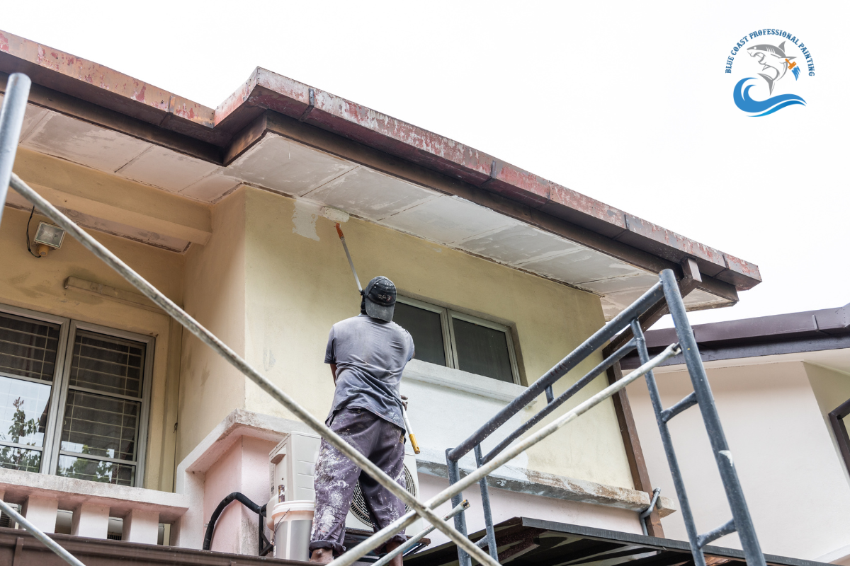 A painter applying a fresh coat of paint to an exterior wall in Lakewood, California.