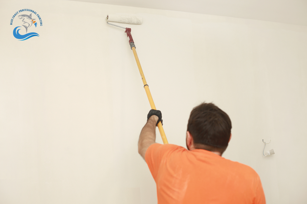 A painter painting the wall of a South Bay, California home.