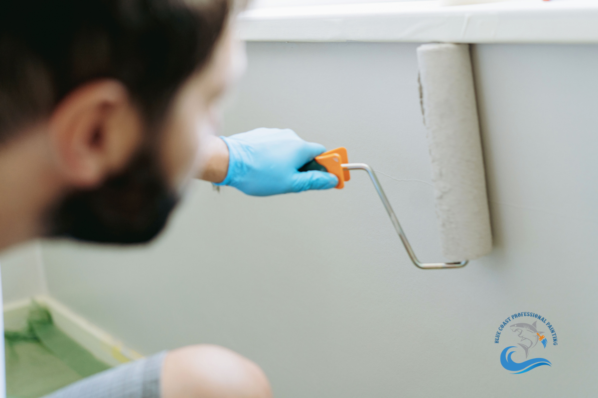 A painter applying a fresh coat of paint in a house in San Fernando Valley, California.